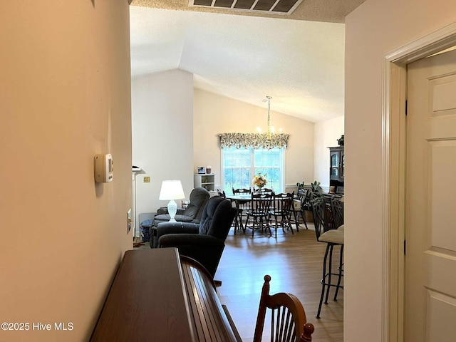 5707 Mossberg Ct, Wilmington, NC 28405 - living room with lofted ceiling, a chandelier, and wood finished floors