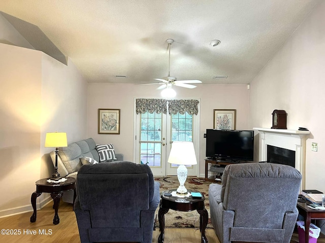 5707 Mossberg Ct, Wilmington, NC 28405 - living area featuring wood finished floors, a ceiling fan, a fireplace, and a textured ceiling