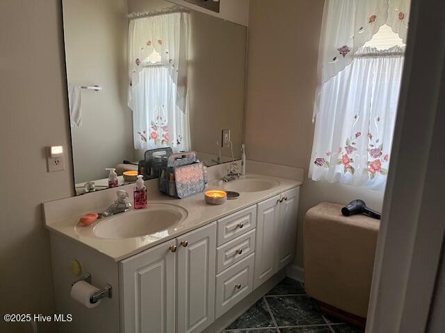 5707 Mossberg Ct, Wilmington, NC 28405 - bathroom with healthy amount of natural light, double vanity, and marble look tile flooring