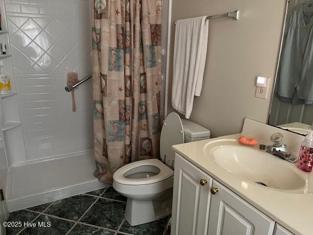 5707 Mossberg Ct, Wilmington, NC 28405 - bathroom with vanity, shower / bath combo with shower curtain, and tile patterned floors