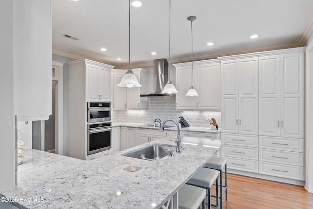 3059 Irwin Dr SE, Southport, NC 28461 - kitchen with a sink, wall chimney exhaust hood, crown molding, white cabinets, and decorative backsplash