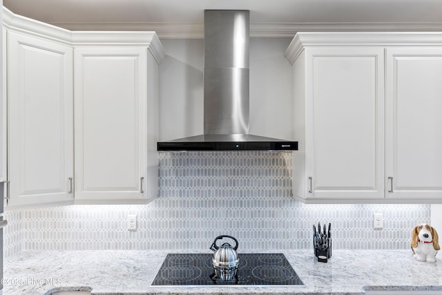 3059 Irwin Dr SE, Southport, NC 28461 - kitchen featuring wall chimney exhaust hood, black electric stovetop, white cabinets, backsplash, and crown molding