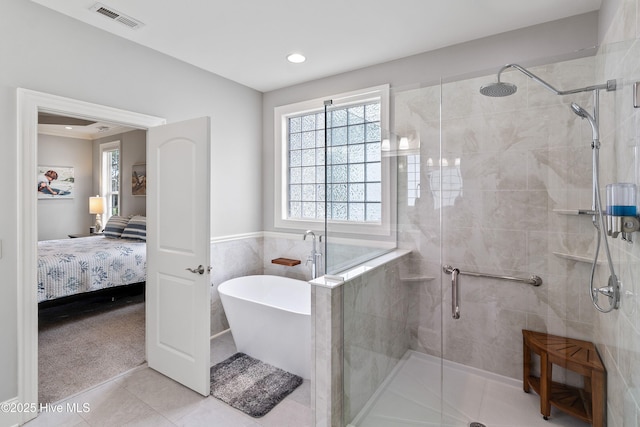 3059 Irwin Dr SE, Southport, NC 28461 - ensuite bathroom with a stall shower, a freestanding tub, recessed lighting, and tile patterned flooring