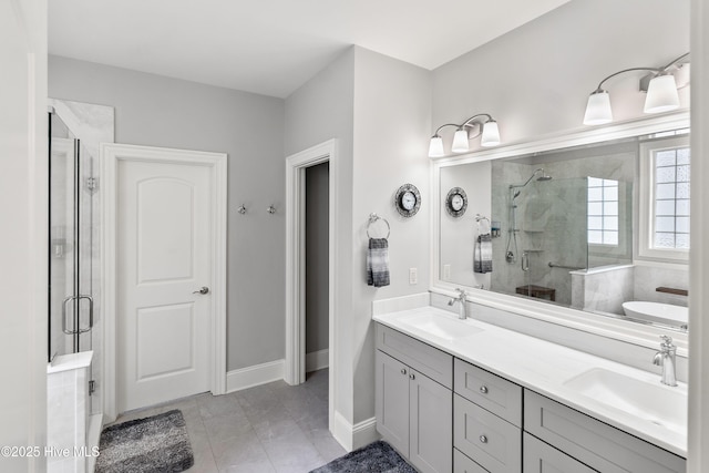 3059 Irwin Dr SE, Southport, NC 28461 - bathroom featuring a shower stall, double vanity, a freestanding tub, and baseboards
