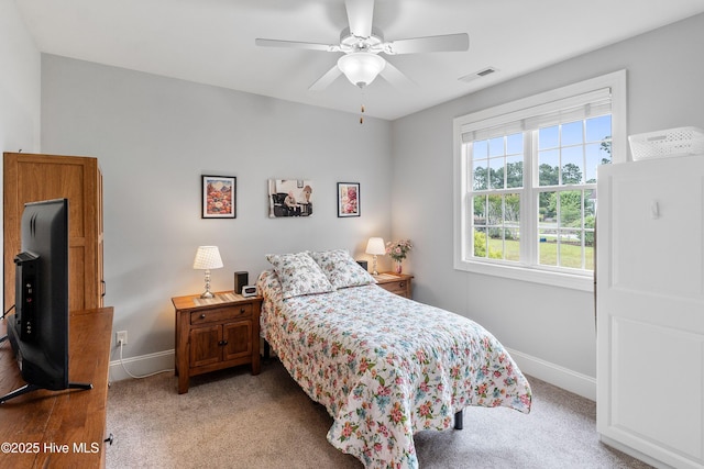 3059 Irwin Dr SE, Southport, NC 28461 - bedroom featuring baseboards, light colored carpet, and ceiling fan