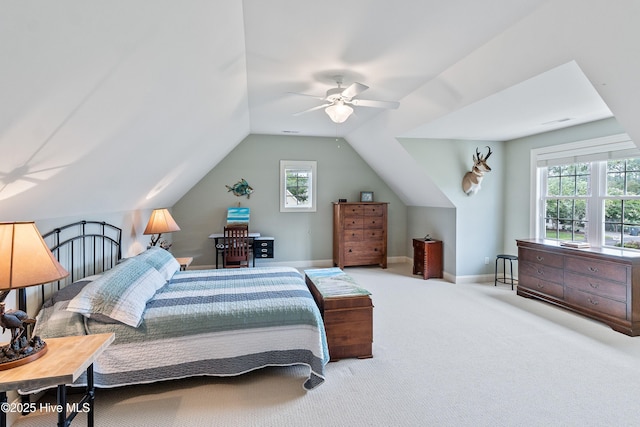 3059 Irwin Dr SE, Southport, NC 28461 - bedroom featuring vaulted ceiling, multiple windows, a ceiling fan, carpet, and baseboards