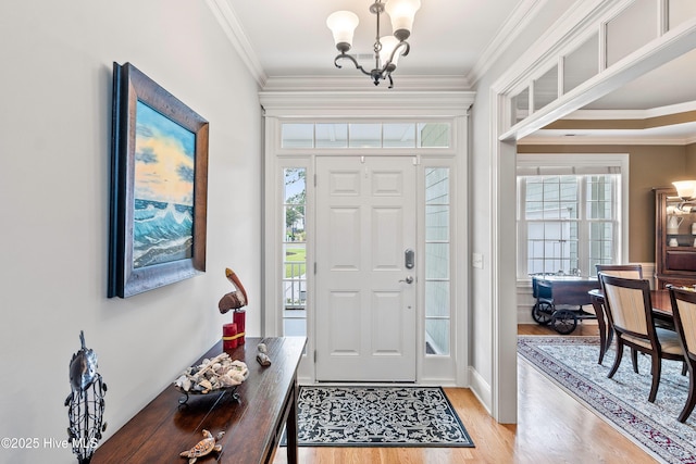 3059 Irwin Dr SE, Southport, NC 28461 - entryway with a chandelier, light wood-style flooring, and ornamental molding