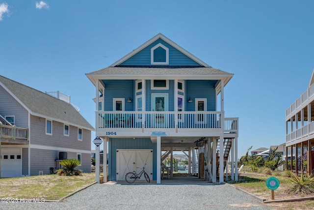 1904 Ocean Blvd, Topsail Beach, NC 28445 - beach home with a carport, driveway, roof with shingles, and covered porch