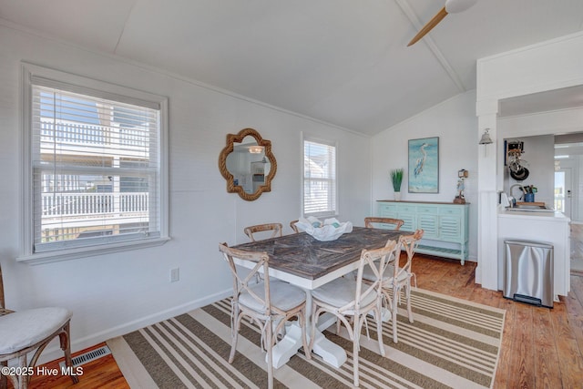 1904 Ocean Blvd, Topsail Beach, NC 28445 - dining room featuring lofted ceiling, plenty of natural light, light wood-style flooring, baseboards, and ceiling fan