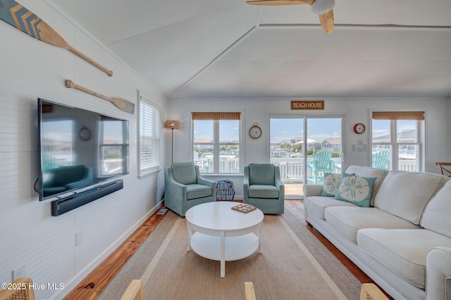 1904 Ocean Blvd, Topsail Beach, NC 28445 - living area featuring wood finished floors, healthy amount of natural light, vaulted ceiling, ceiling fan, and baseboards
