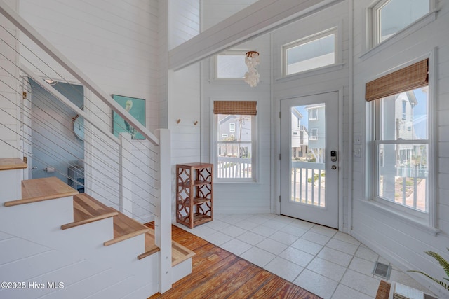 1904 Ocean Blvd, Topsail Beach, NC 28445 - entryway featuring healthy amount of natural light, stairway, a high ceiling, and wood finished floors