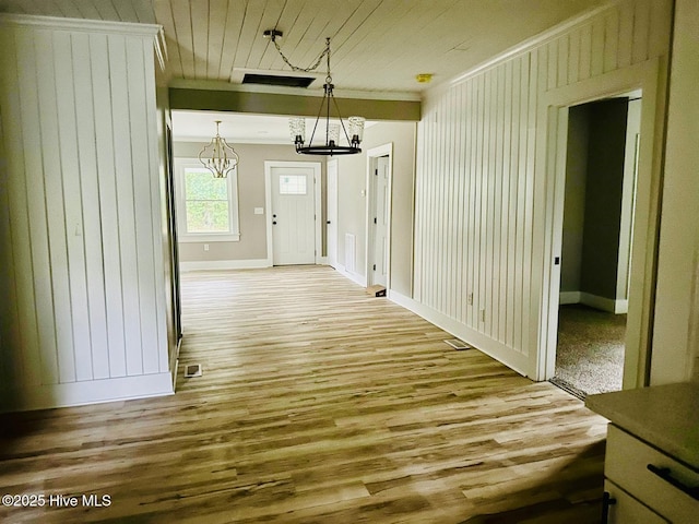 1200 N Center St, Goldsboro, NC 27530 - corridor with a chandelier, wood finished floors, baseboards, wood ceiling, and ornamental molding