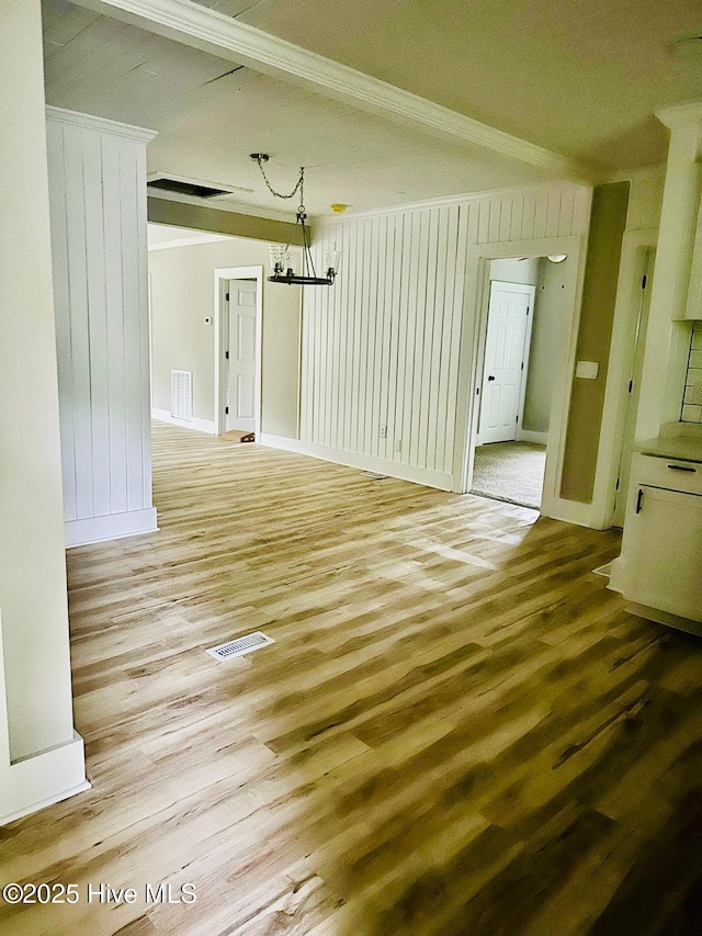 1200 N Center St, Goldsboro, NC 27530 - spare room with wood finished floors, ornamental molding, baseboards, and a chandelier
