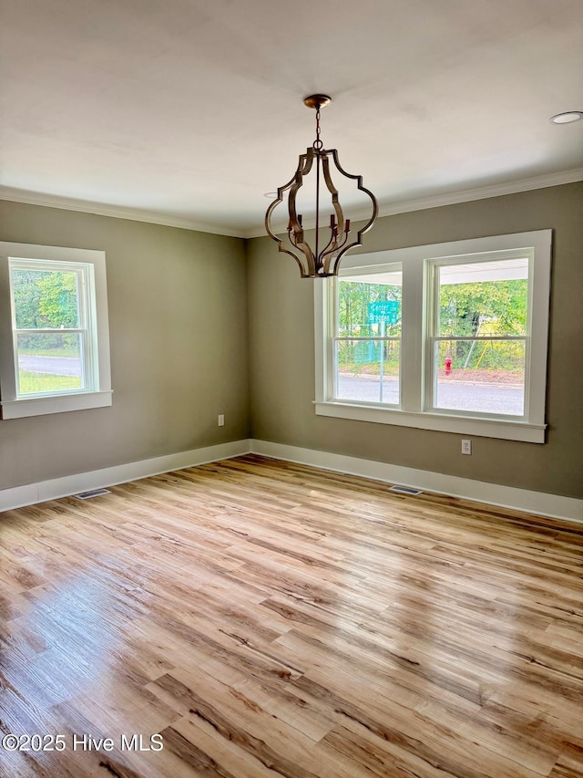 1200 N Center St, Goldsboro, NC 27530 - unfurnished room with plenty of natural light, crown molding, wood finished floors, and baseboards