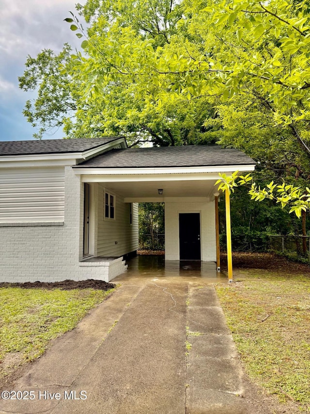 1200 N Center St, Goldsboro, NC 27530 - view of vehicle parking with driveway and a carport