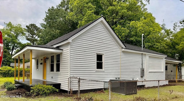 1200 N Center St, Goldsboro, NC 27530 - view of home's exterior with covered porch, central AC unit, and roof with shingles