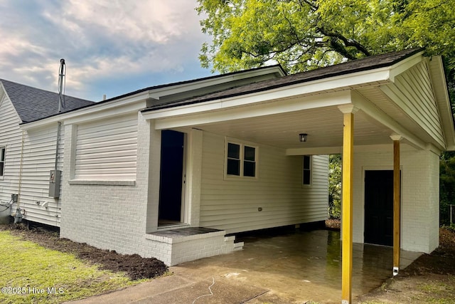 1200 N Center St, Goldsboro, NC 27530 - exterior space featuring brick siding, an attached carport, and a shingled roof
