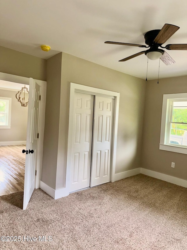 1200 N Center St, Goldsboro, NC 27530 - unfurnished bedroom featuring carpet floors, multiple windows, a chandelier, and baseboards