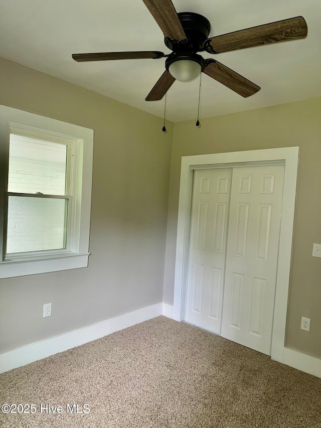 1200 N Center St, Goldsboro, NC 27530 - unfurnished bedroom with carpet, a closet, baseboards, and ceiling fan