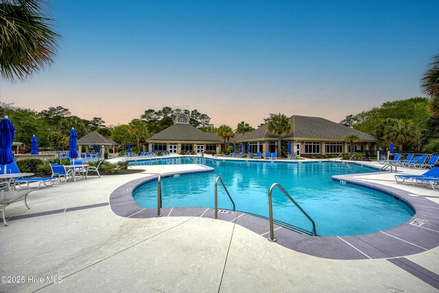 6804 Marston Pt SW Unit 76, Ocean Isle Beach, NC 28469 - pool at dusk featuring a patio area and a community pool