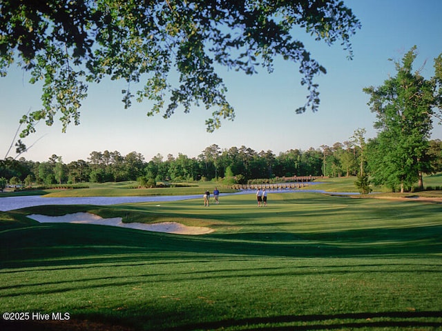 6804 Marston Pt SW Unit 76, Ocean Isle Beach, NC 28469 - view of home's community featuring golf course view, view of scattered trees, a lawn, and a water view