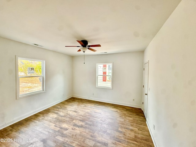 216 S Tillery St, Rocky Mount, NC 27804 - spare room with healthy amount of natural light, wood finished floors, a ceiling fan, and baseboards