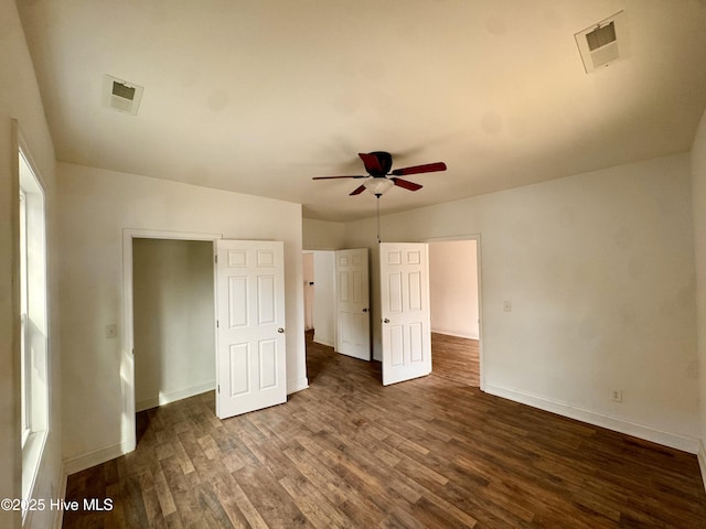 216 S Tillery St, Rocky Mount, NC 27804 - unfurnished bedroom with dark wood-type flooring, baseboards, and a ceiling fan
