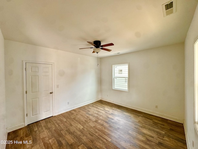 216 S Tillery St, Rocky Mount, NC 27804 - spare room featuring dark wood-style flooring, a ceiling fan, and baseboards