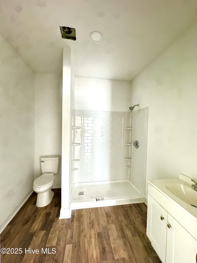 216 S Tillery St, Rocky Mount, NC 27804 - full bath featuring toilet, tiled shower, wood finished floors, vanity, and baseboards