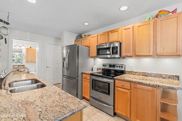 3350 Club Villas Dr # 1403, Southport, NC 28461 - kitchen with appliances with stainless steel finishes, a sink, light stone countertops, open shelves, and a textured ceiling