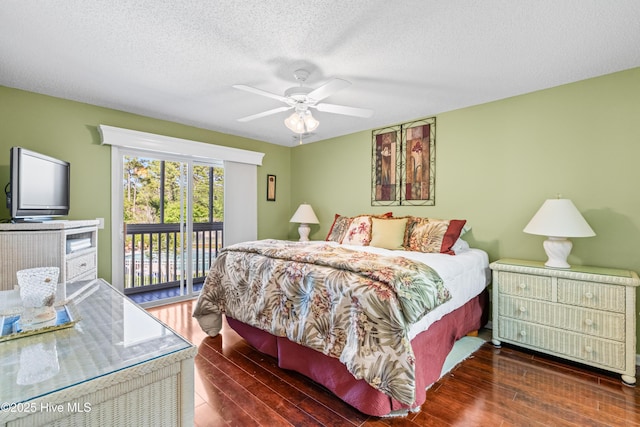 3350 Club Villas Dr # 1403, Southport, NC 28461 - bedroom featuring access to outside, wood finished floors, a textured ceiling, and ceiling fan