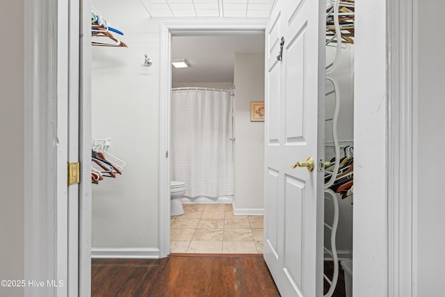 3350 Club Villas Dr # 1403, Southport, NC 28461 - hallway featuring baseboards and wood finished floors