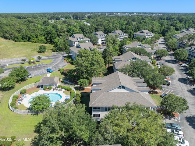3350 Club Villas Dr # 1403, Southport, NC 28461 - drone / aerial view of a pool and a heavily wooded area