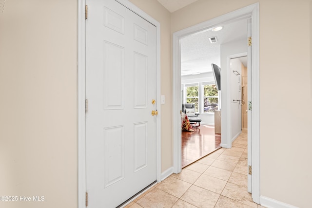 3350 Club Villas Dr # 1403, Southport, NC 28461 - foyer featuring light tile patterned floors and baseboards