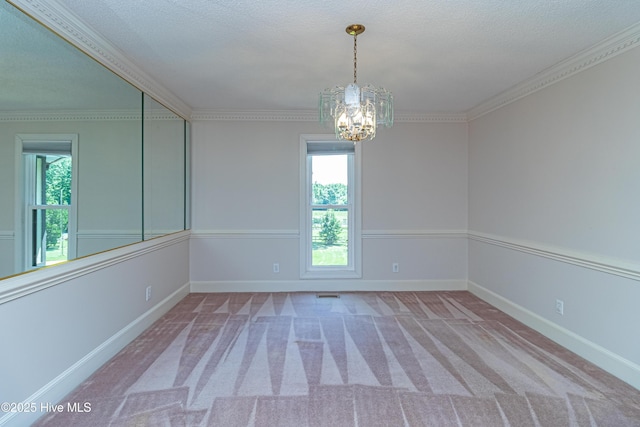 102 Plantation Rd, Goldsboro, NC 27530 - carpeted spare room with a chandelier, healthy amount of natural light, baseboards, crown molding, and a textured ceiling