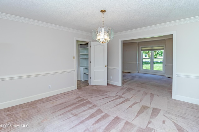 102 Plantation Rd, Goldsboro, NC 27530 - carpeted spare room with crown molding, a chandelier, a textured ceiling, and baseboards