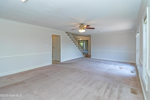 102 Plantation Rd, Goldsboro, NC 27530 - empty room with stairs, ceiling fan, a textured ceiling, light carpet, and ornamental molding