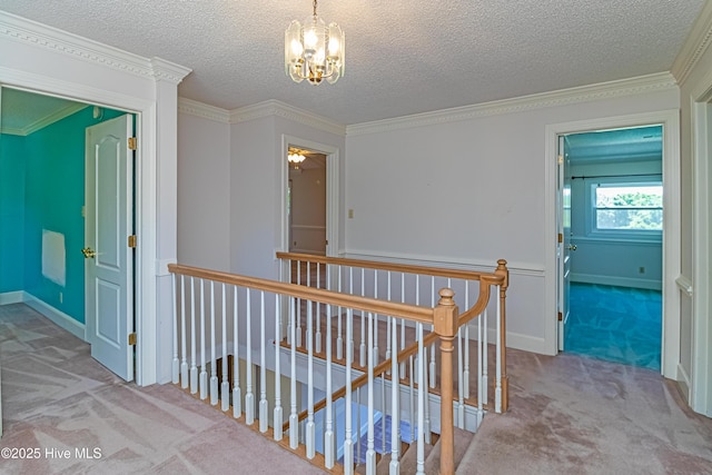 102 Plantation Rd, Goldsboro, NC 27530 - corridor with an upstairs landing, carpet flooring, a chandelier, a textured ceiling, and crown molding