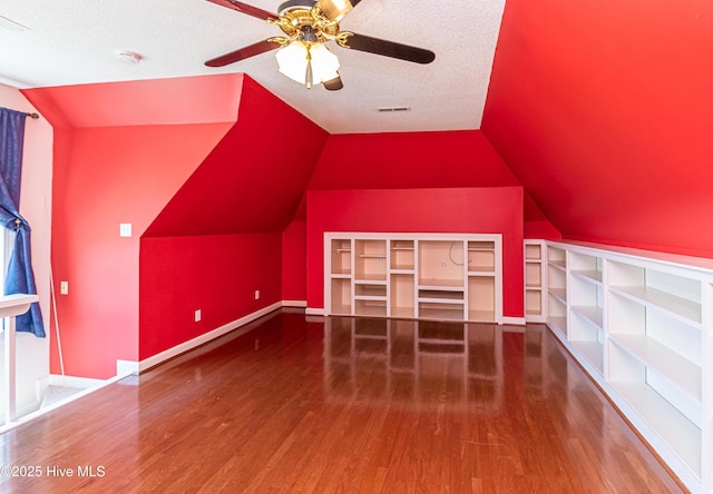 102 Plantation Rd, Goldsboro, NC 27530 - bonus room featuring wood finished floors, lofted ceiling, a ceiling fan, baseboards, and a textured ceiling