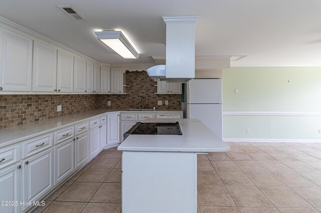 102 Plantation Rd, Goldsboro, NC 27530 - kitchen with a sink, freestanding refrigerator, light tile patterned flooring, decorative backsplash, and white cabinets