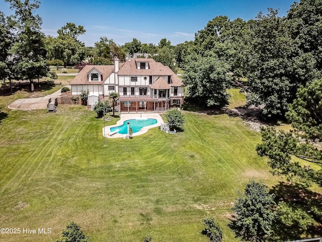 102 Plantation Rd, Goldsboro, NC 27530 - back of property featuring a yard, an outdoor pool, a balcony, a chimney, and a patio area