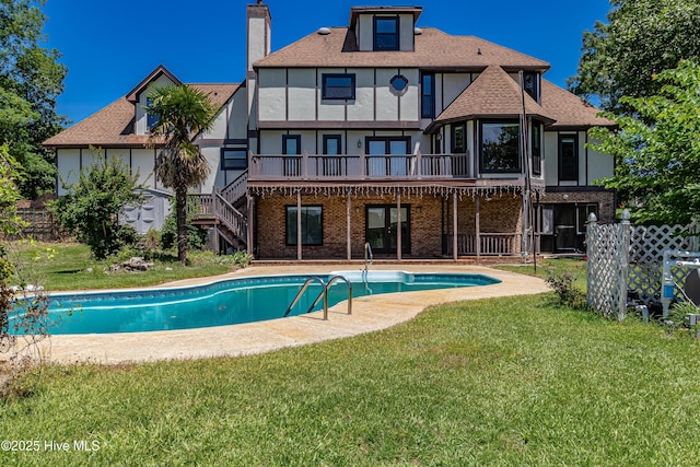 102 Plantation Rd, Goldsboro, NC 27530 - back of house with a yard, stucco siding, an outdoor pool, and roof with shingles