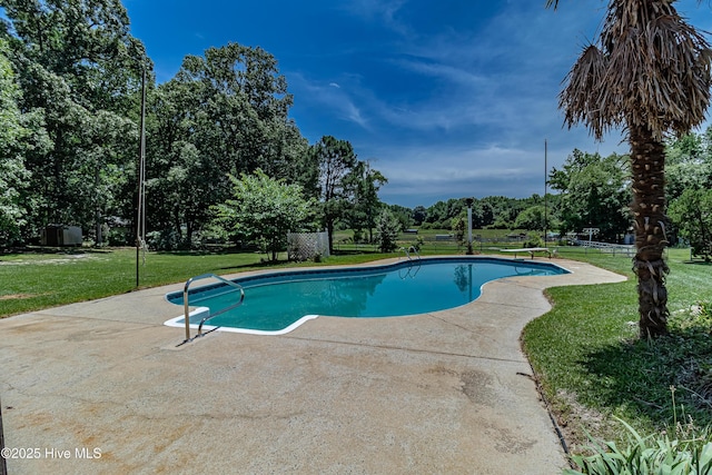 102 Plantation Rd, Goldsboro, NC 27530 - view of swimming pool featuring a patio area, a yard, and view of wooded area