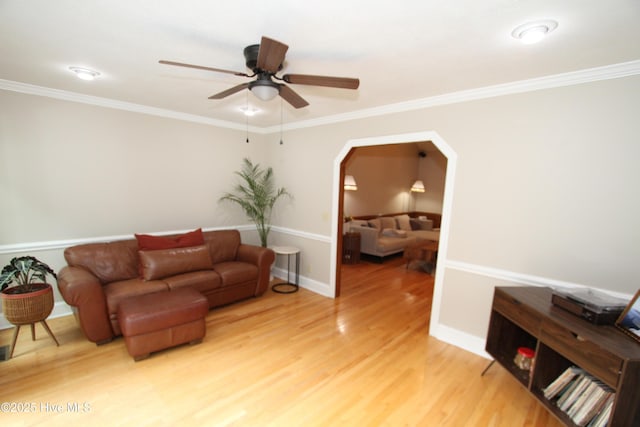 1317 Worthington Ln, Greenville, NC 27858 - living area featuring ceiling fan, light wood finished floors, crown molding, and arched walkways
