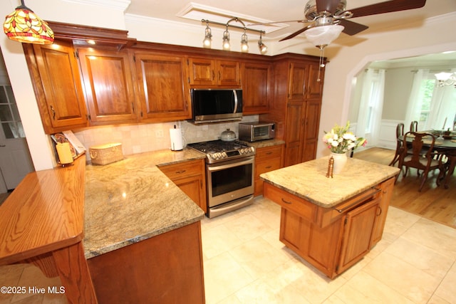 1317 Worthington Ln, Greenville, NC 27858 - kitchen with stainless steel appliances, a ceiling fan, light stone counters, backsplash, and crown molding