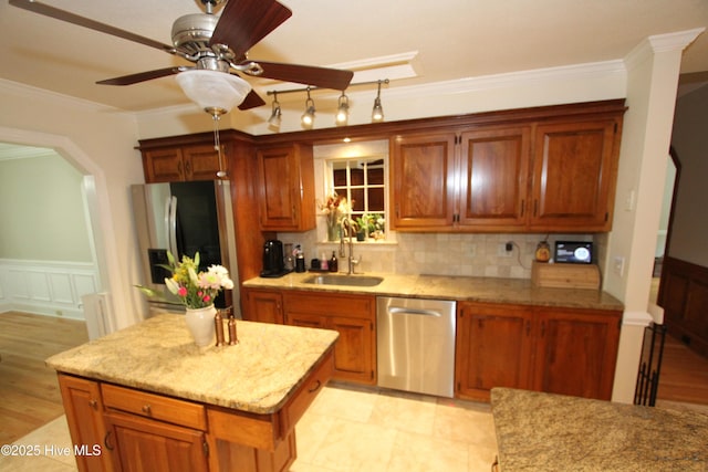 1317 Worthington Ln, Greenville, NC 27858 - kitchen with stainless steel appliances, crown molding, decorative backsplash, a kitchen island, and brown cabinets