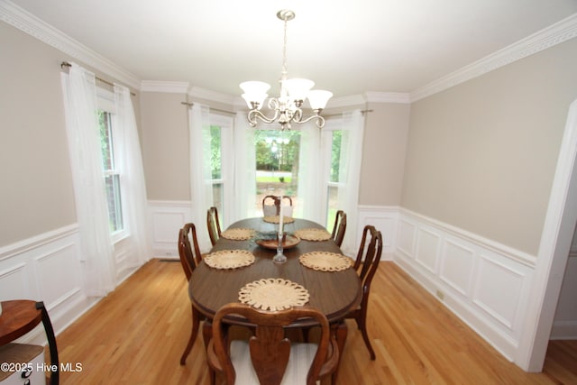 1317 Worthington Ln, Greenville, NC 27858 - dining space featuring a decorative wall, light wood-style floors, a chandelier, wainscoting, and crown molding
