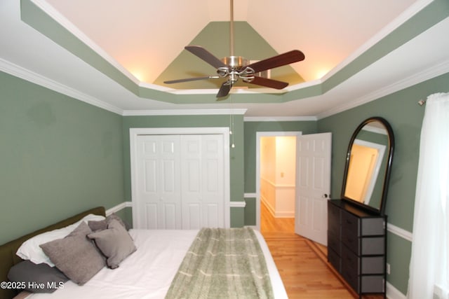 1317 Worthington Ln, Greenville, NC 27858 - bedroom with a raised ceiling, light wood-style floors, a closet, ceiling fan, and crown molding