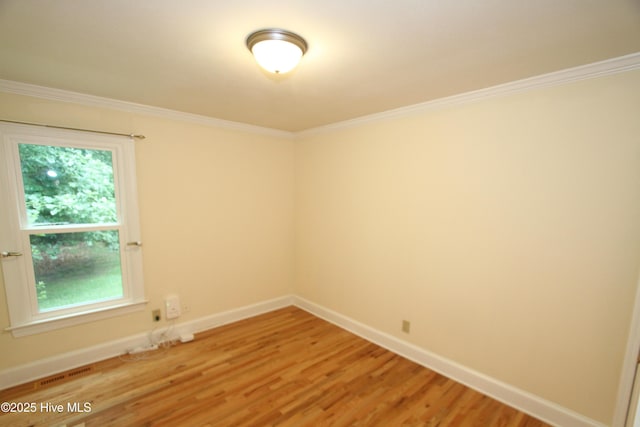 1317 Worthington Ln, Greenville, NC 27858 - spare room featuring light wood-style flooring, crown molding, and healthy amount of natural light