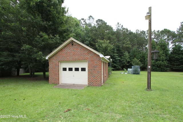 1317 Worthington Ln, Greenville, NC 27858 - detached garage with driveway and view of scattered trees
